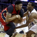 New Orleans Pelicans forward Anthony Davis, left, keeps a rebound away from Phoenix Suns forward T.J. Warren in the first half of an NBA basketball game in New Orleans, Sunday, Nov. 22, 2015. (AP Photo/Max Becherer)