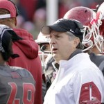 Washington State head coach Mike Leach, center, speaks in the huddle during a timeout in the first half of an NCAA college football game against Arizona State, Saturday, Nov. 7, 2015, in Pullman, Wash. (AP Photo/Young Kwak)