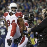 Arizona Cardinals tight end Jermaine Gresham holds the football behind his back as a television camera records his celebration after his touchdown reception against the Seattle Seahawks during the second half of an NFL football game, Sunday, Nov. 15, 2015, in Seattle. (AP Photo/Elaine Thompson)