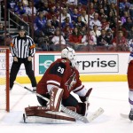 New York Rangers' Emerson Etem (96) creates a screen in front of Arizona Coyotes' Anders Lindback (29), of Sweden, as Rangers' Kevin Hayes scores during the second period of an NHL hockey game Saturday, Nov. 7, 2015, in Glendale, Ariz. (AP Photo/Ross D. Franklin)