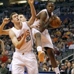 Phoenix Suns' Archie Goodwin, right, grabs a rebound over teammate Jon Leuer (30) during the first half of an NBA basketball game against the Denver Nuggets, Saturday, Nov. 14, 2015, in Phoenix. (AP Photo/Ralph Freso)