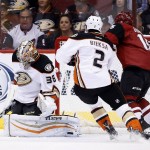 Anaheim Ducks' John Gibson (36) makes a save as Ducks' Kevin Bieksa (2) and Arizona Coyotes' Boyd Gordon, right, wait for a possible rebound during the first period of an NHL hockey game Wednesday, Nov. 25, 2015, in Glendale, Ariz. (AP Photo/Ross D. Franklin)