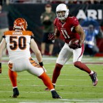 Arizona Cardinals wide receiver Larry Fitzgerald (11) makes a catch as Cincinnati Bengals outside linebacker A.J. Hawk (50) defends during the first half of an NFL  football game, Sunday, Nov. 22, 2015, in Glendale, Ariz. (AP Photo/Ross D. Franklin)
