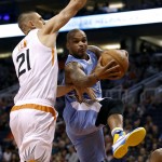 Denver Nuggets guard Jameer Nelson, right, drives to the basket under Phoenix Suns' Alex Len during the first half of an NBA basketball game, Saturday, Nov. 14, 2015, in Phoenix. (AP Photo/Ralph Freso)