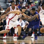 Toronto Raptors' Luis Scola, left, and Phoenix Suns' Eric Bledsoe chase down a loose ball during the first half of an NBA basketball game in Toronto on Sunday, Nov. 29, 2015. (Darren Calabrese/The Canadian Press via AP) MANDATORY CREDIT