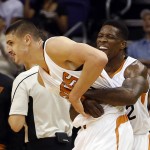 Phoenix Suns center Alex Len, left, and Eric Bledsoe celebrate a foul in the first quarter during an NBA basketball game against the New Orleans Pelicans, Wednesday, Nov. 25, 2015, in Phoenix. (AP Photo/Rick Scuteri)