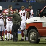 An ambulance is brought in to take injured Arizona Cardinals guard Mike Iupati off the field after a play against the Seattle Seahawks during the first half of an NFL football game, Sunday, Nov. 15, 2015, in Seattle. (AP Photo/Elaine Thompson)