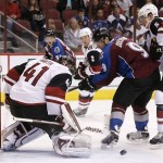 Arizona Coyotes' Mike Smith (41) makes a kick-save on a shot by Colorado Avalanche's Matt Duchene (9) as Coyotes' Connor Murphy (5) and Nicklas Grossmann (2), of Sweden, defend during the first period of an NHL hockey game Thursday, Nov. 5, 2015, in Glendale, Ariz. (AP Photo/Ross D. Franklin)