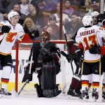Calgary Flames' Mark Giordano celebrates his goal against Arizona Coyotes' Mike Smith, second from left, with teammates Johnny Gaudreau (13), Jiri Hudler (24), of the Czech Republic, and Sean Monahan, left, during the second period of an NHL hockey game Friday, Nov. 27, 2015, in Glendale, Ariz. (AP Photo/Ross D. Franklin)