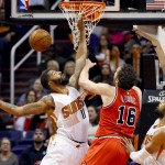 Phoenix Suns forward Markieff Morris (11) fouls Chicago Bulls center Pau Gasol, of Spain, (16) during the second half of an NBA basketball game Wednesday, Nov. 18, 2015, in Phoenix. (AP Photo/Matt York)