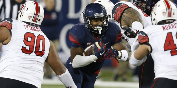 Arizona running back Jared Baker carries the ball during the first half of an NCAA college football...