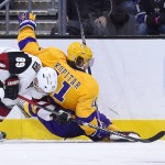 Arizona Coyotes left wing Mikkel Boedker, left, of Denmark, and Los Angeles Kings center Anze Kopitar, of Slovenia, battle for the puck during the first period of an NHL hockey game, Tuesday, Nov. 10, 2015, in Los Angeles. (AP Photo/Mark J. Terrill)