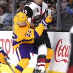 Los Angeles Kings center Trevor Lewis, left, and Arizona Coyotes defenseman Oliver Ekman-Larsson, of Sweden, battle for the puck during the first period of an NHL hockey game, Tuesday, Nov. 10, 2015, in Los Angeles. (AP Photo/Mark J. Terrill)