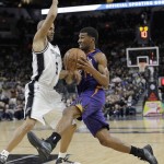 Phoenix Suns' Ronnie Price (14) tries to drive around San Antonio Spurs' Tony Parker (9) during the first half of an NBA basketball game, Monday, Nov. 23, 2015, in San Antonio. (AP Photo/Eric Gay)