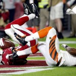 Arizona Cardinals wide receiver John Brown (12) tumbles in the end zone after scoring a touchdown as Cincinnati Bengals cornerback Darqueze Dennard, right, falls backwards during the second half of an NFL football game, Sunday, Nov. 22, 2015, in Glendale, Ariz. (AP Photo/Ross D. Franklin)