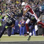 Seattle Seahawks free safety Earl Thomas (29) intercepts a pass intended for Arizona Cardinals wide receiver Michael Floyd, top, as Seahawks outside linebacker K.J. Wright (50) watches during the first half of an NFL football game, Sunday, Nov. 15, 2015, in Seattle. (AP Photo/Stephen Brashear)