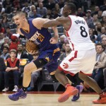 Phoenix Suns' Alex Len, left, is fouled by Toronto Raptors' Bismack Biyombo during the second half of an NBA basketball game in Toronto on Sunday, Nov. 29, 2015. (Darren Calabrese/The Canadian Press via AP) MANDATORY CREDIT