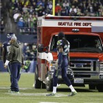 An ambulance is brought in to take injured Arizona Cardinals guard Mike Iupati off the field, during the first half of the Cardinals' NFL football game against the Seattle Seahawks on Sunday, Nov. 15, 2015, in Seattle. (AP Photo/Elaine Thompson)