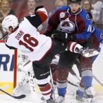 Colorado Avalanche's Nikita Zadorov, right, of Russia, checks Arizona Coyotes' Max Domi, left, off the puck during the first period of an NHL hockey game Thursday, Nov. 5, 2015, in Glendale, Ariz. (AP Photo/Ross D. Franklin)