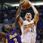 Phoenix Suns' Alex Len (21), of Ukraine, gets fouled by Los Angeles Lakers' Brandon Bass (2) as he goes up for a shot during the second half of an NBA basketball game Monday, Nov. 16, 2015, in Phoenix.  The Suns defeated the Lakers 120-101. (AP Photo/Ross D. Franklin)