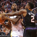 Golden State Warriors forward Harrison Barnes draws the foul on Phoenix Suns guard Eric Bledsoe (2) in the second quarter during an NBA basketball game, Friday, Nov. 27, 2015, in Phoenix. (AP Photo/Rick Scuteri)