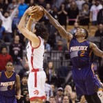 Phoenix Suns' Eric Bledsoe, right, blocks Toronto Raptors' Luis Scola's shot attempt during the second half of an NBA basketball game in Toronto on Sunday, Nov. 29, 2015. (Darren Calabrese/The Canadian Press via AP) MANDATORY CREDIT