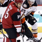 Arizona Coyotes' Boyd Gordon (15) and Anaheim Ducks' Mike Santorelli (25) battle after a face off during the first period of an NHL hockey game Wednesday, Nov. 25, 2015, in Glendale, Ariz. (AP Photo/Ross D. Franklin)