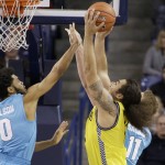 Northern Arizona's Ako Kaluna, right, grabs a rebound against of Gonzaga's Silas Melson (0) and Domantas Sabonis (11) during the second half of an NCAA college basketball game, Wednesday, Nov. 18, 2015, in Spokane, Wash. Gonzaga won 91-52. (AP Photo/Young Kwak)