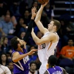 Phoenix Suns' John Leuer (30) shoots over Sacramento Kings' Marco Belinelli, of Italy, during the first half of an NBA basketball game, Wednesday, Nov. 4, 2015, in Phoenix. (AP Photo/Matt York)