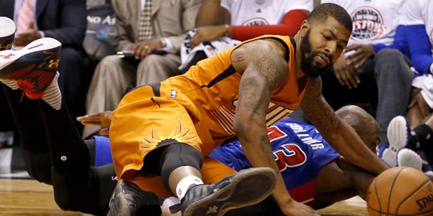 Phoenix Suns forward Markieff Morris, left, and Detroit Pistons forward Anthony Tolliver scramble o...