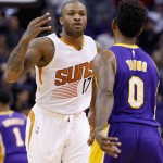 Phoenix Suns' P.J. Tucker (17) gestures with his hand after making a 3-pointer as Los Angeles Lakers' Nick Young (0) looks on during the first half of an NBA basketball game Monday, Nov. 16, 2015, in Phoenix. (AP Photo/Ross D. Franklin)