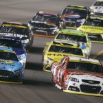 Kevin Harvick (4) leads Joey Logano (22) and the rest of the field into Turn 1 during the NASCAR Sprint Cup Series auto race at Phoenix International Raceway, Sunday, Nov. 15, 2015, in Avondale, Ariz. (AP Photo/Ralph Freso)