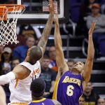 Los Angeles Lakers' Jordan Clarkson (6) battles Phoenix Suns' Tyson Chandler, left, for a rebound as Lakers' Roy Hibbert (17) watches during the first half of an NBA basketball game Monday, Nov. 16, 2015, in Phoenix. (AP Photo/Ross D. Franklin)