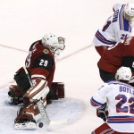 Arizona Coyotes' Anders Lindback (29), of Sweden, makes a save on a shot as Coyotes' Connor Murphy (5) and New York Rangers' Dan Boyle (22) and Derek Stepan (21) watch during the third period of an NHL hockey game Saturday, Nov. 7, 2015, in Glendale, Ariz. The Rangers defeated the Coyotes 4-1. (AP Photo/Ross D. Franklin)