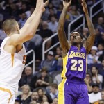Los Angeles Lakers' Louis Williams (23) shoots over Phoenix Suns' Alex Len, left, of Ukraine, during the first half of an NBA basketball game Monday, Nov. 16, 2015, in Phoenix. (AP Photo/Ross D. Franklin)