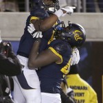 California running back Tre Watson, top, celebrates with teammates after scoring on a touchdown run against Arizona State during the second half of an NCAA college football game in Berkeley, Calif., Saturday, Nov. 28, 2015. (AP Photo/Jeff Chiu)