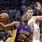 Los Angeles Lakers' Metta World Peace, left, gets fouled as he goes up for a shot as Phoenix Suns' Jon Leuer, right, defends during the first half of an NBA basketball game Monday, Nov. 16, 2015, in Phoenix. (AP Photo/Ross D. Franklin)
