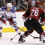 New York Rangers' Chris Kreider (20) controls the puck in front of Arizona Coyotes' Michael Stone (26) just before his slap shot score during the second period of an NHL hockey game, Saturday, Nov. 7, 2015, in Glendale, Ariz. (AP Photo/Ross D. Franklin)