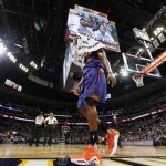 Phoenix Suns guard Brandon Knight covers his head with a towel as he limps off the court after injuring an ankle while driving the lane for a shot against the Denver Nuggets in the first half of an NBA basketball game Friday, Nov. 20, 2015, in Denver. (AP Photo/David Zalubowski)