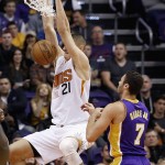 Phoenix Suns' Alex Len (21) dunks in front of Los Angeles Lakers' Larry Nance Jr. (7) during the first half of an NBA basketball game Monday, Nov. 16, 2015, in Phoenix. (AP Photo/Ross D. Franklin)