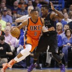 Oklahoma City Thunder guard Russell Westbrook (0) drives around Phoenix Suns guard Eric Bledsoe, right, in the first quarter of an NBA basketball game in Oklahoma City, Sunday, Nov. 8, 2015. (AP Photo/Sue Ogrocki)