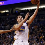 Golden State Warriors guard Klay Thompson scores against the Phoenix Suns in the first quarter during an NBA basketball game, Friday, Nov. 27, 2015, in Phoenix. (AP Photo/Rick Scuteri)