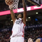 Toronto Raptors' Lucas Nogueira, left, dunks in front of Phoenix Suns' Jon Leuer during the first half of an NBA basketball game in Toronto on Sunday, Nov. 29, 2015. (Darren Calabrese/The Canadian Press via AP) MANDATORY CREDIT