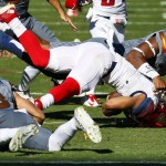 Arizona wide receiver Nate Phillips (6) is knocked to the turf after being tripped up by Arizona State wide receiver D.J. Foster (8) during the first half of an NCAA college football game, Saturday, Nov. 21, 2015, in Tempe, Ariz. (AP Photo/Matt York)