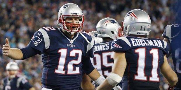 New England Patriots quarterback Tom Brady (12) celebrates his touchdown pass to wide receiver Juli...