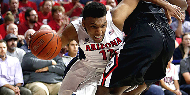 Arizona guard Allonzo Trier, left, drives around Fresno State center Terrell Carter II during the s...