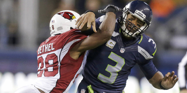 Seattle Seahawks quarterback Russell Wilson (3) is hit by Arizona Cardinals cornerback Justin Bethe...