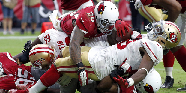 San Francisco 49ers running back Carlos Hyde (28) is tackled in the end zone for a safety by Arizon...