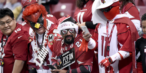 Arizona Cardinals fans are seen before the start of an NFL football game between the St. Louis Rams...