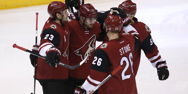 Arizona Coyotes left wing Mikkel Boedker (89) celebrates with teammates after scoring in the first ...